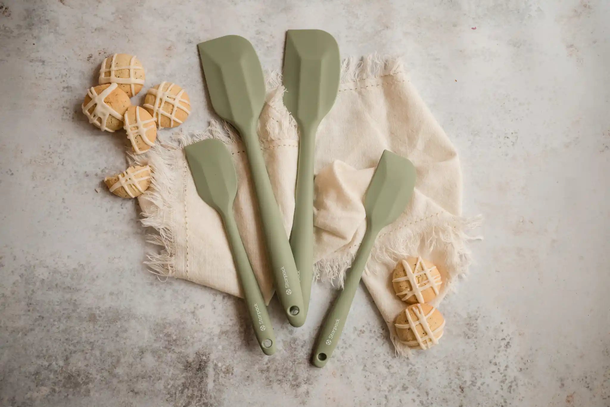 Starpack silicone kitchen utensils set, featuring various tools with non-stick heads and sturdy handles for versatile cooking.