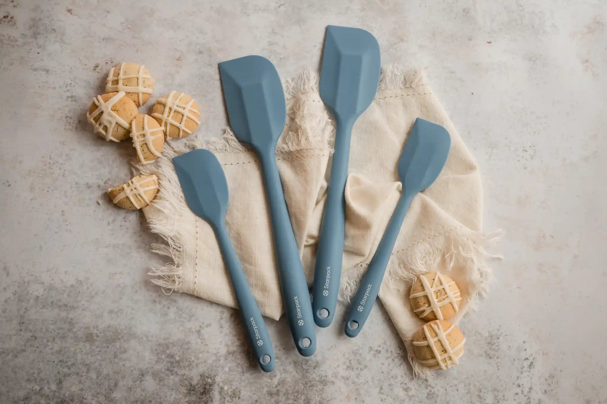 Starpack silicone kitchen utensils set, featuring various tools with non-stick heads and sturdy handles for versatile cooking.